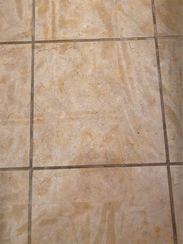 A close up of a tiled floor with a black border.