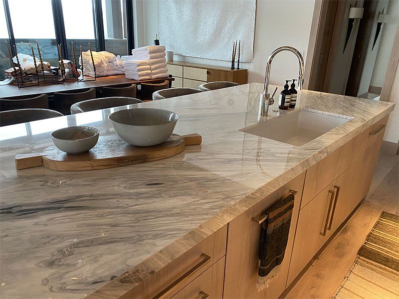 A kitchen counter with a sink and bowls on it.