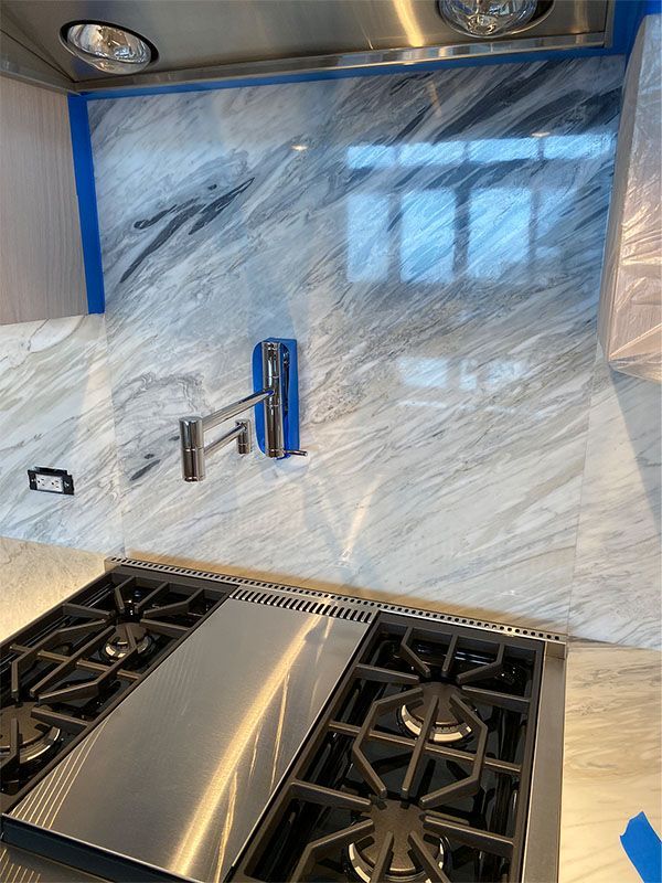 A stainless steel stove top oven is sitting on top of a counter in a kitchen.