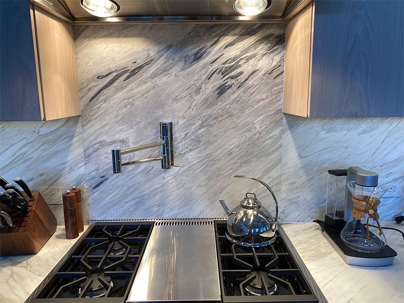 A kitchen with a stove and a kettle on it