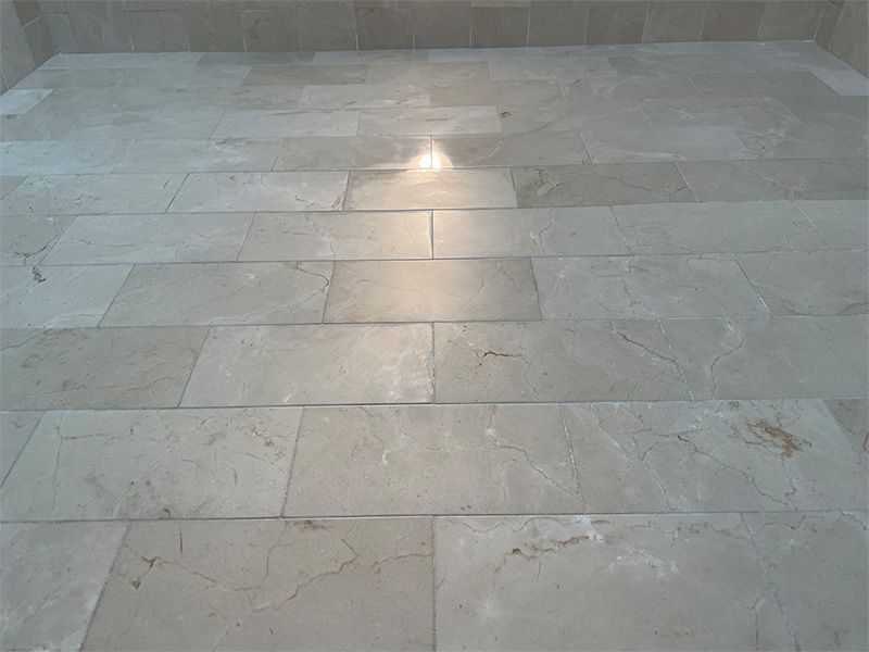 A close up of a tiled floor with a light shining through it.