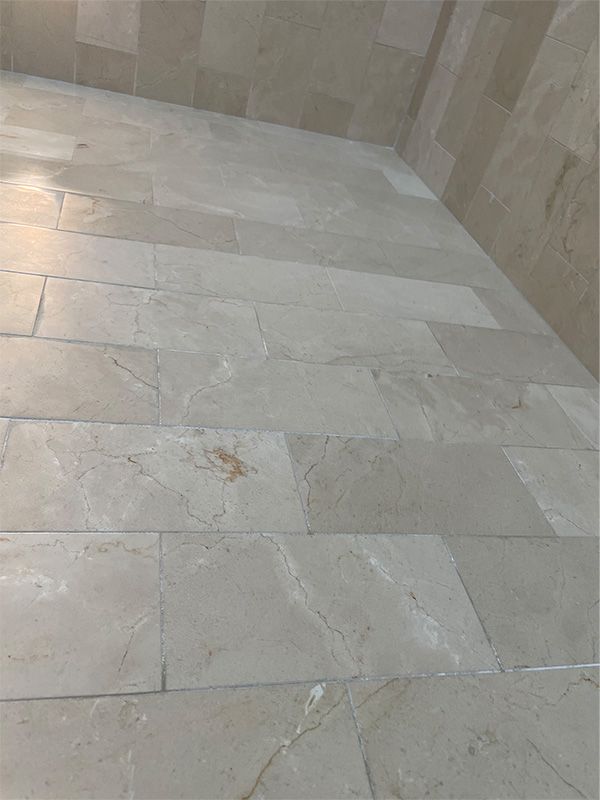 A close up of a tiled floor next to a wall.