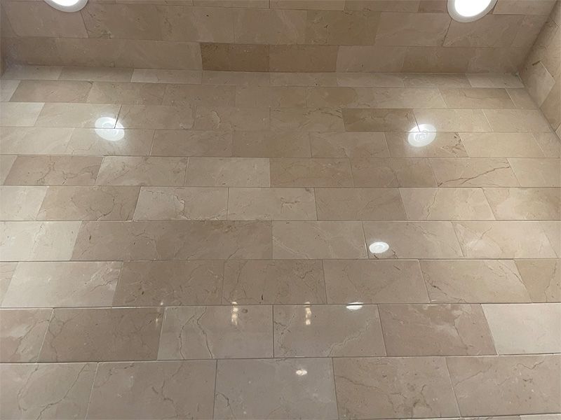 A close up of a tiled floor with a ceiling in the background.