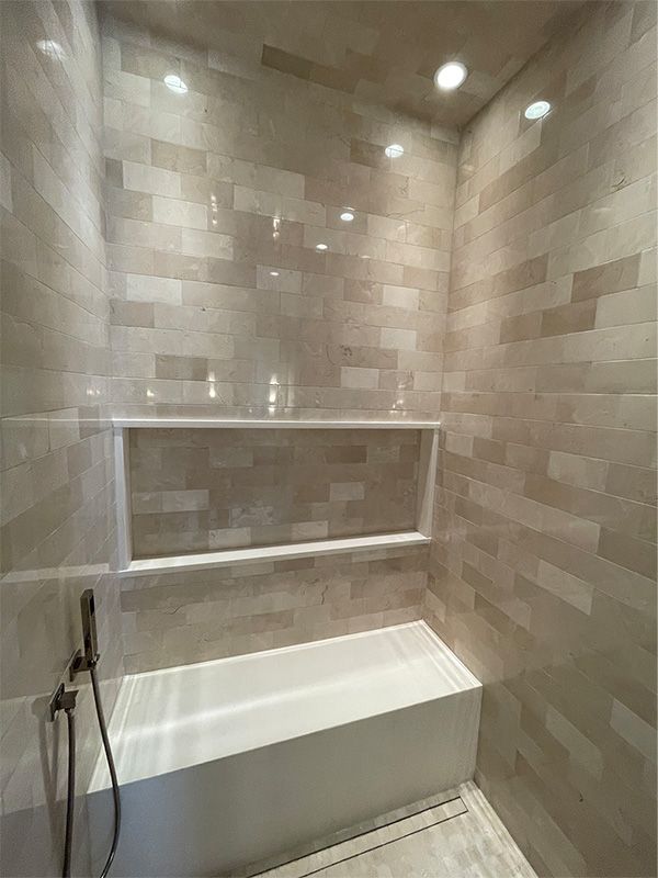 A bathroom with a bathtub and a shower.