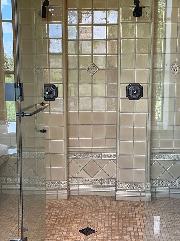 A bathroom with a walk in shower and tiled walls