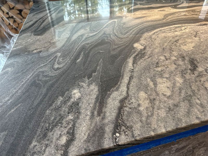 A close up of a granite counter top with a swirl pattern.
