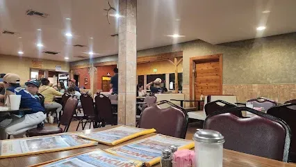 A group of people are sitting at tables in a restaurant.