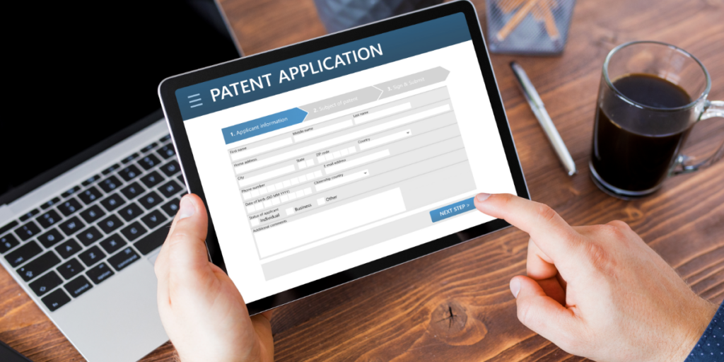 A person is holding a tablet with a patent application on the screen.