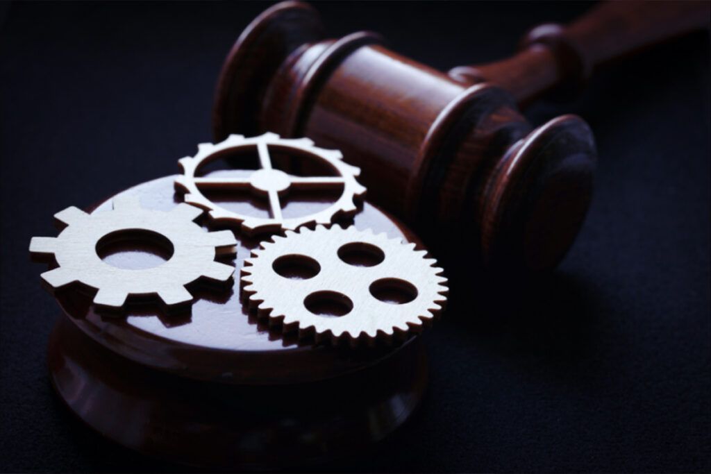 A judge 's gavel with gears on top of it