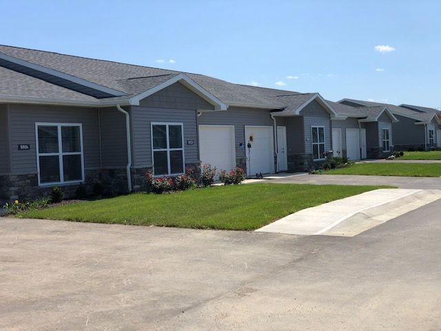 A row of houses are lined up next to each other on a sunny day.