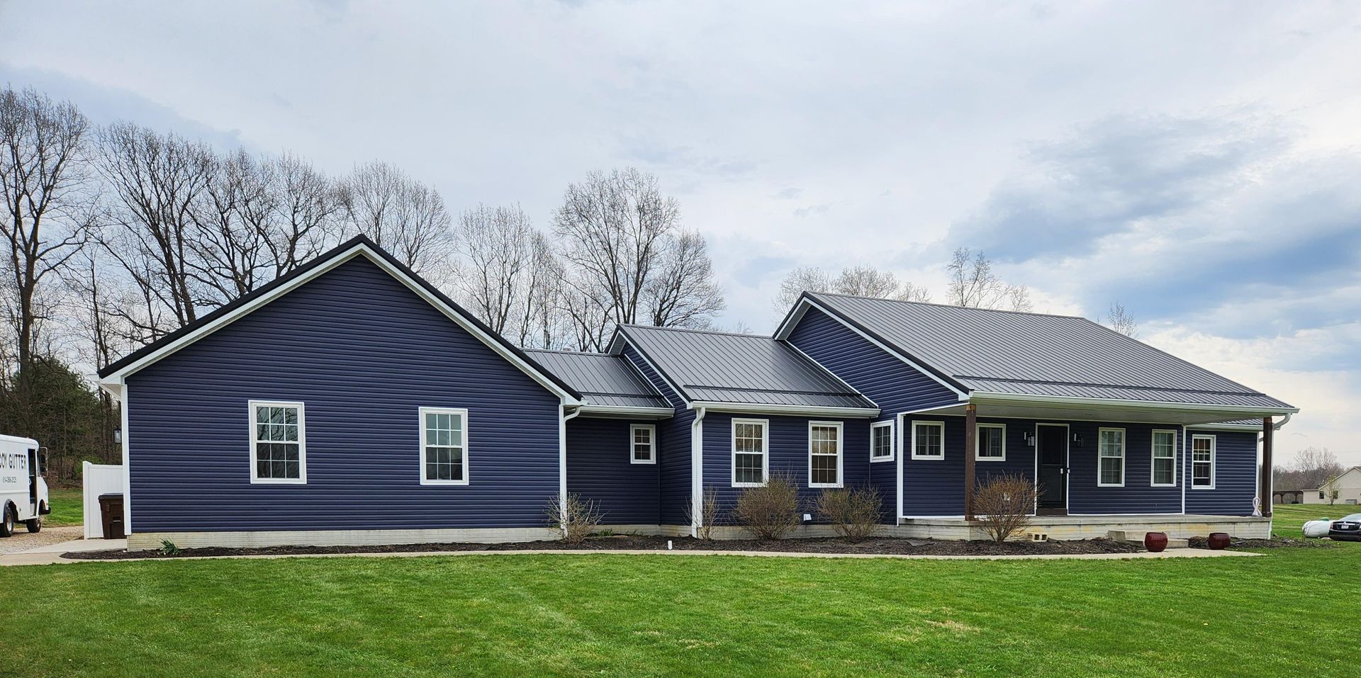 The roof of a house with a blue sky in the background.