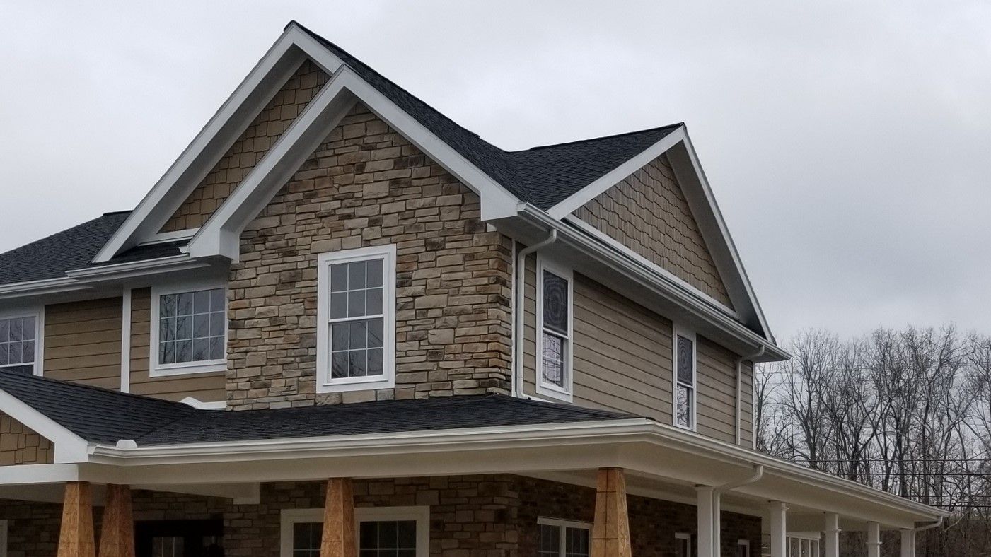 A close up of a metal roof with a blue sky in the background.