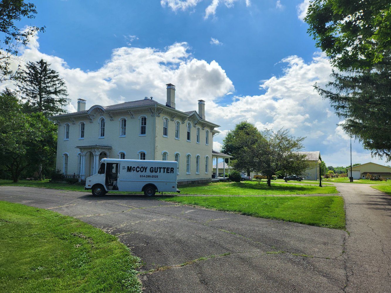 A white house with a gray roof.