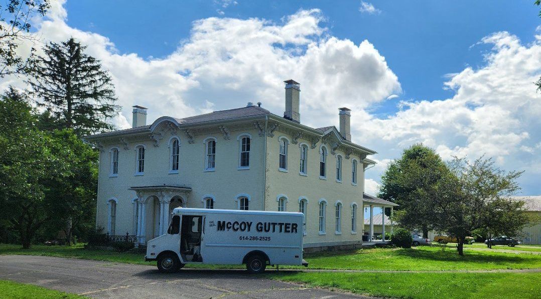 The front of a house with a brown roof.