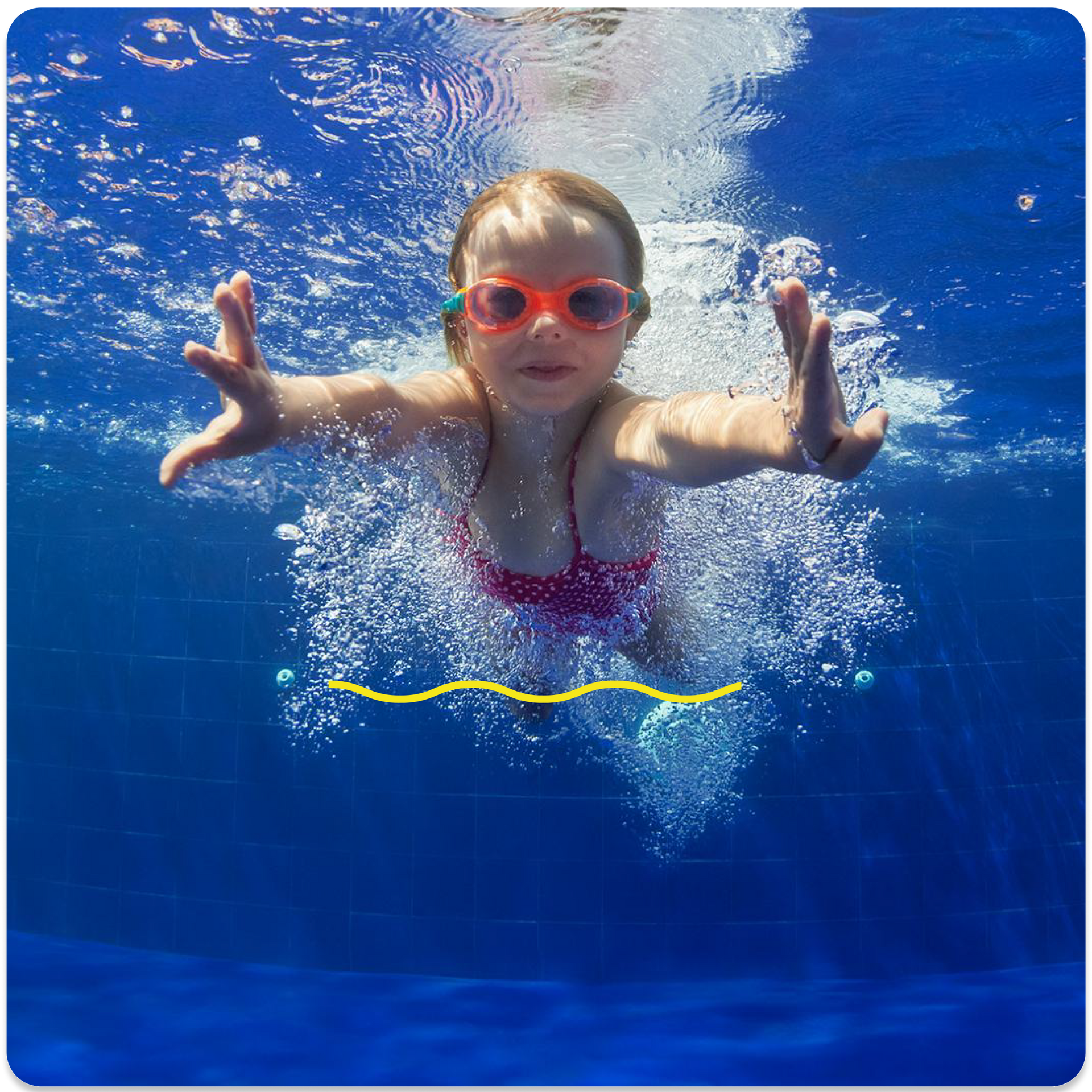 A little girl wearing goggles is swimming in a pool