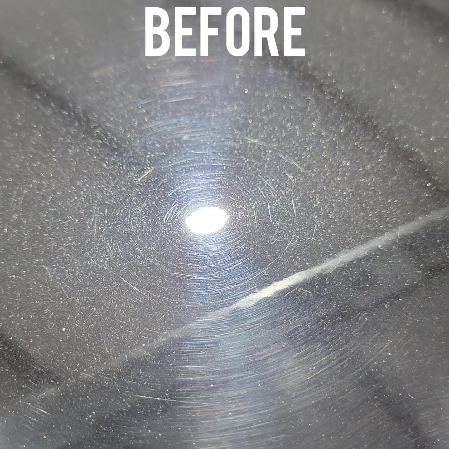 Close-up of a dark, scratched car surface labeled 