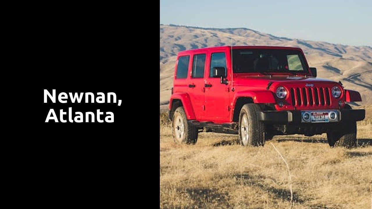 A red jeep is parked in a field with mountains in the background.