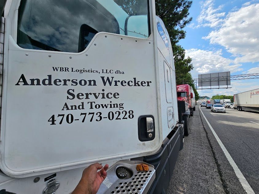 A white truck with Anderson Wrecker Service and Towing written on it