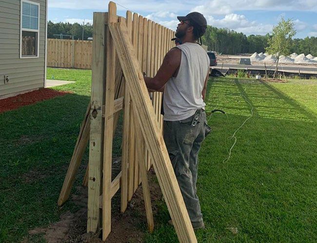 Man Repairing Fence — Hinesville, GA — Hinesville Fence EBG LLC