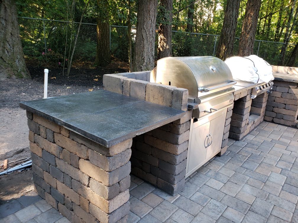 Outdoor patio with seating, dining area, and a view of a green field at sunset. Outdoor patio with seating, dining area, and a view of a green field at sunset.