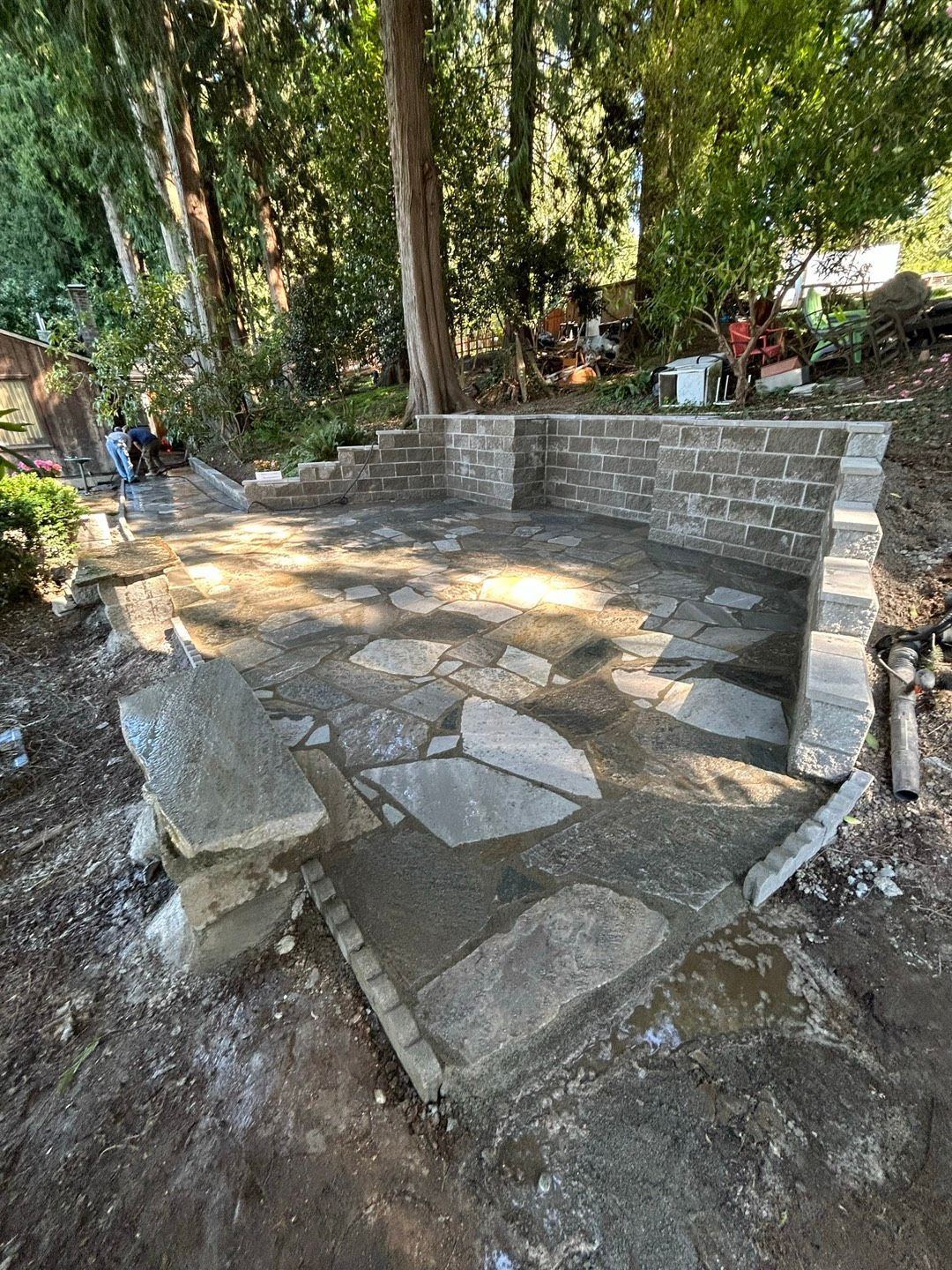 Beige house with a stone yard, green lawn, and blue sky. Beige house with a stone yard, green lawn, and blue sky.