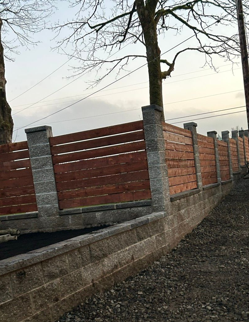 Person wearing yellow gloves laying paving stones on sand. Person wearing yellow gloves laying paving stones on sand.