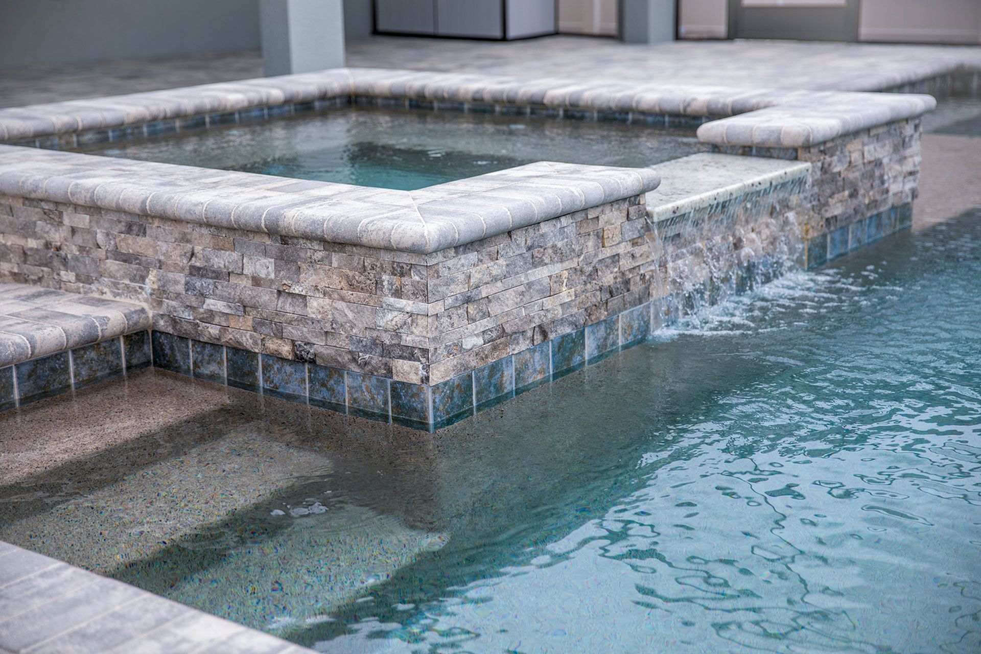 Swimming pool with attached raised hot tub and tile detail. Swimming pool with attached raised hot tub and tile detail.