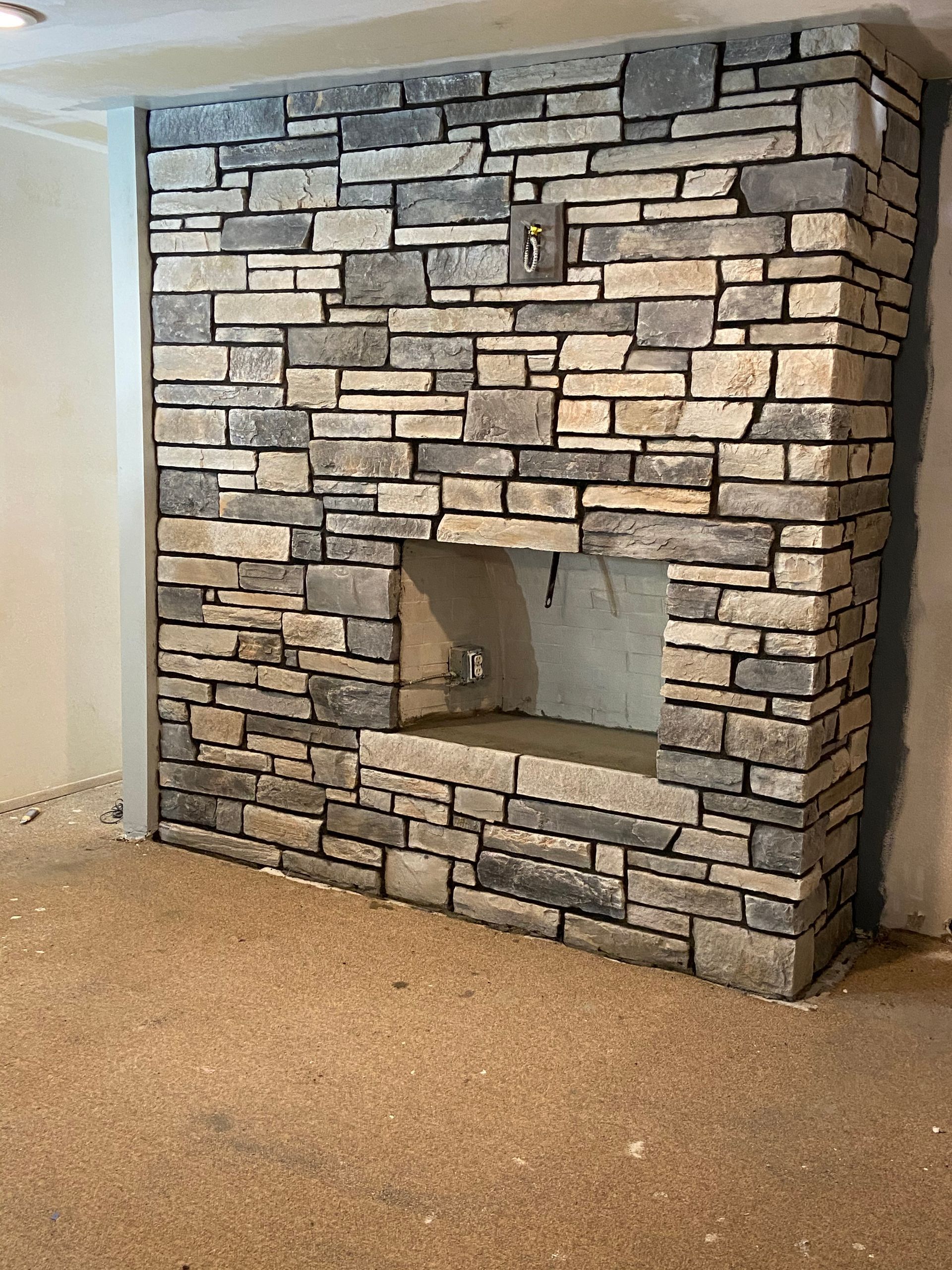 Construction worker laying bricks; red bricks, indoor setting. Construction worker laying bricks; red bricks, indoor setting.