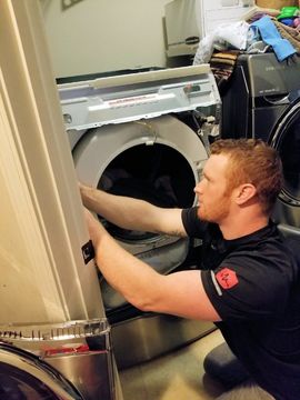 Two Men Pulling Out a Stove — Major Appliance Repair in Oklahoma City, OK