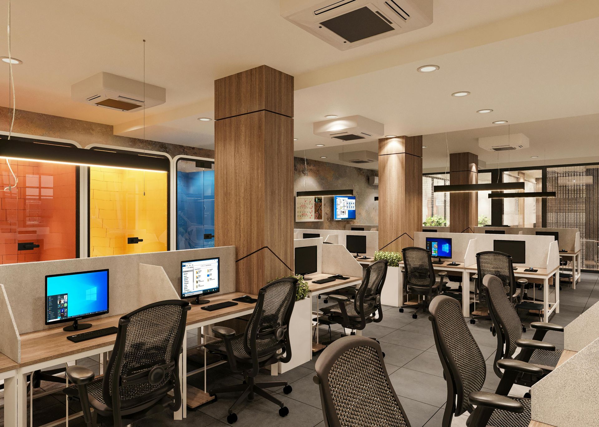 Modern office interior with rows of workstations, computer monitors, and ergonomic chairs in a well-lit space.