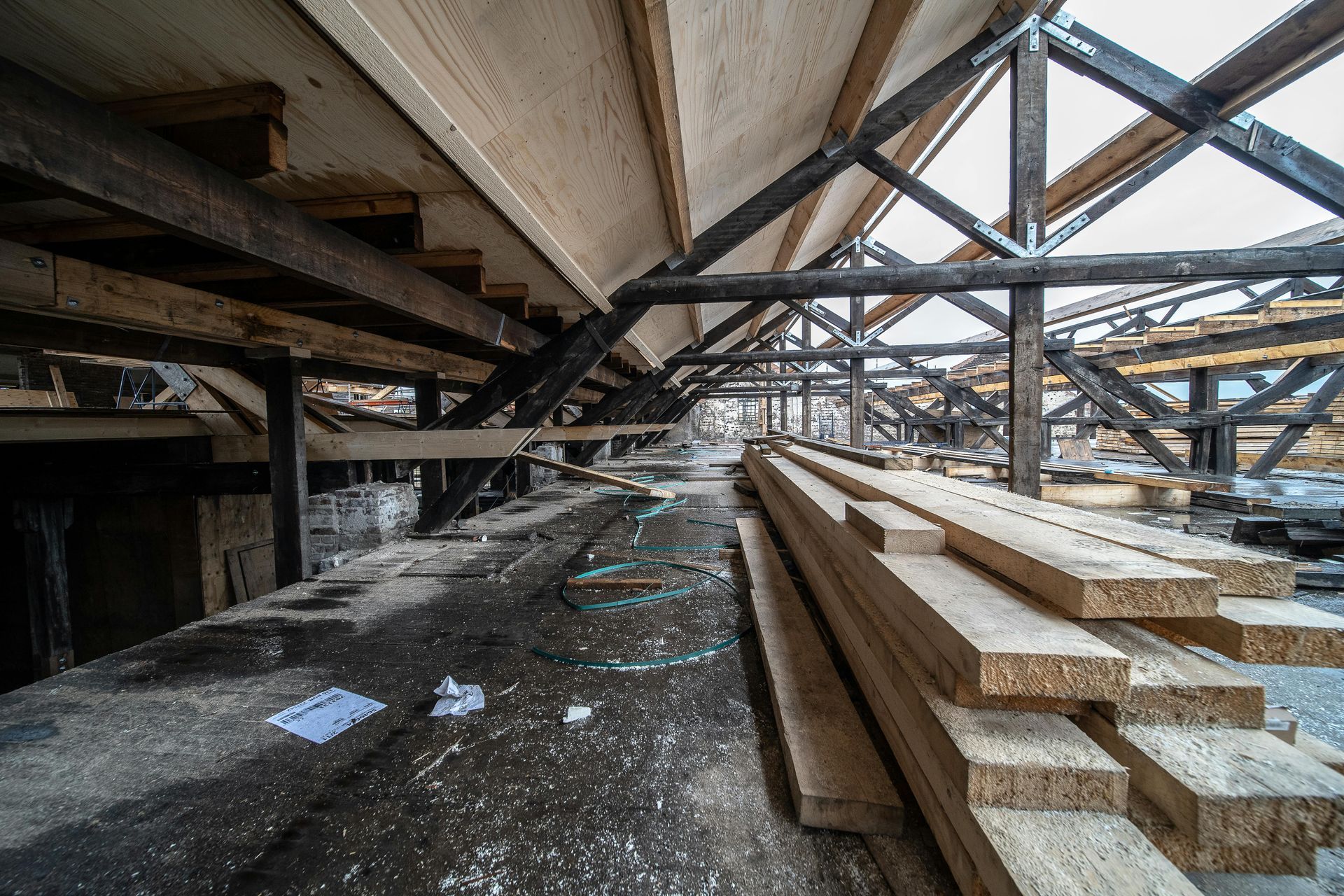 A warehouse filled with lots of wooden beams and lumber.