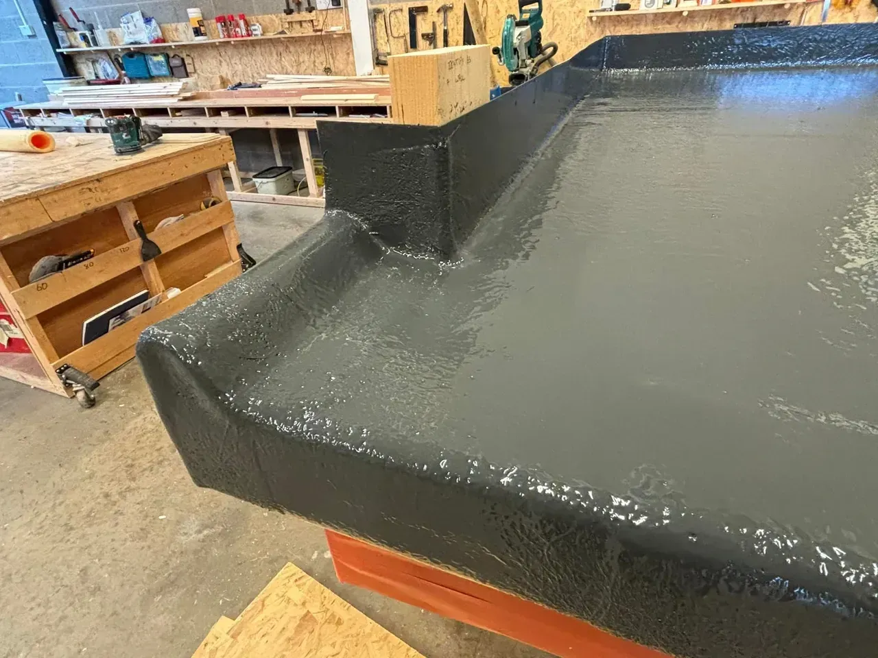 A close up of a black table in a workshop.