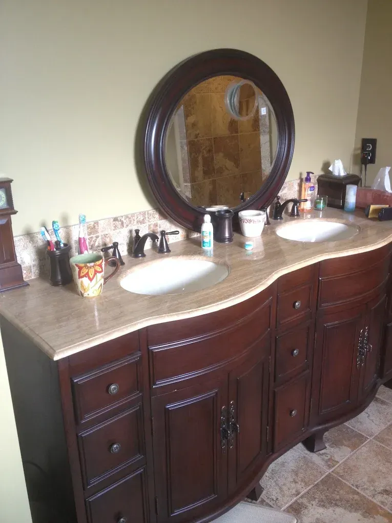A bathroom vanity with two sinks and a mirror
