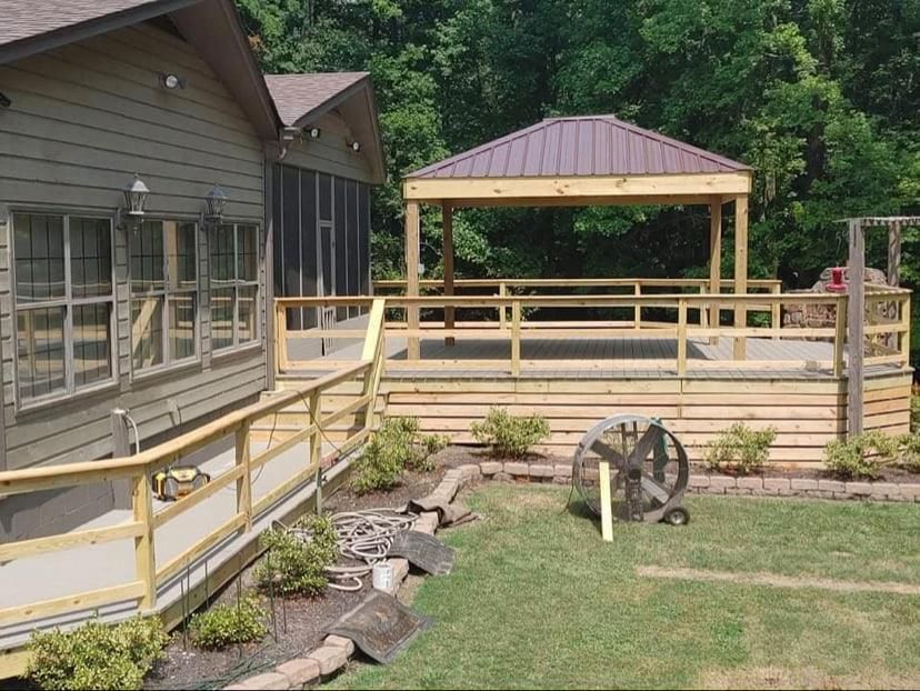 A wooden deck with a gazebo in the backyard