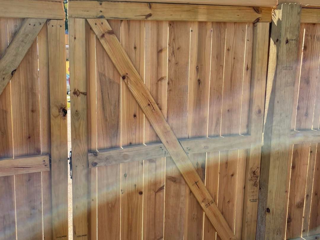 A close up of a wooden fence with the sun shining through it