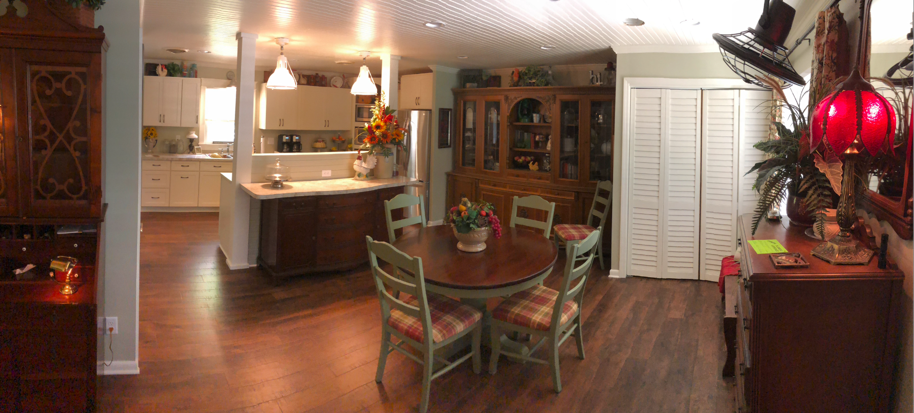 There is a table and chairs in the middle of the room.