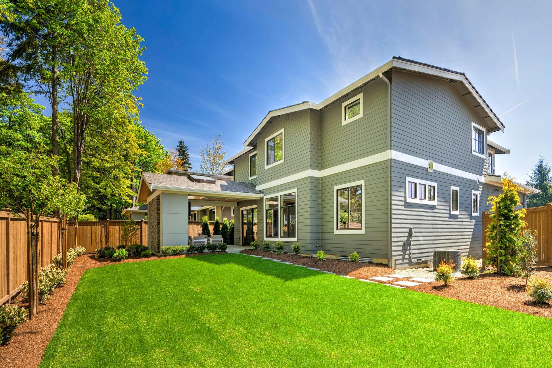 A large house with a lush green lawn in front of it.