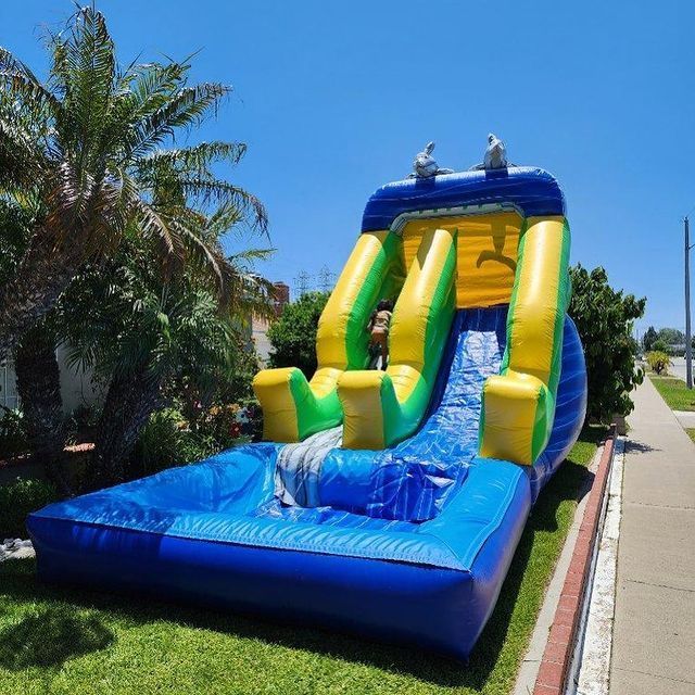 A large inflatable water slide is sitting on the side of the road.