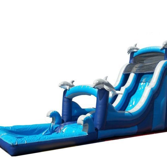 A blue inflatable water slide with dolphins on it
