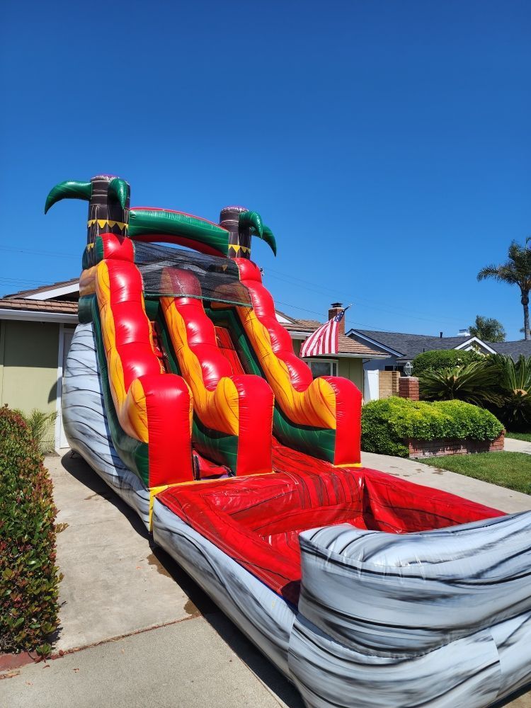 A large inflatable water slide is parked in front of a house.