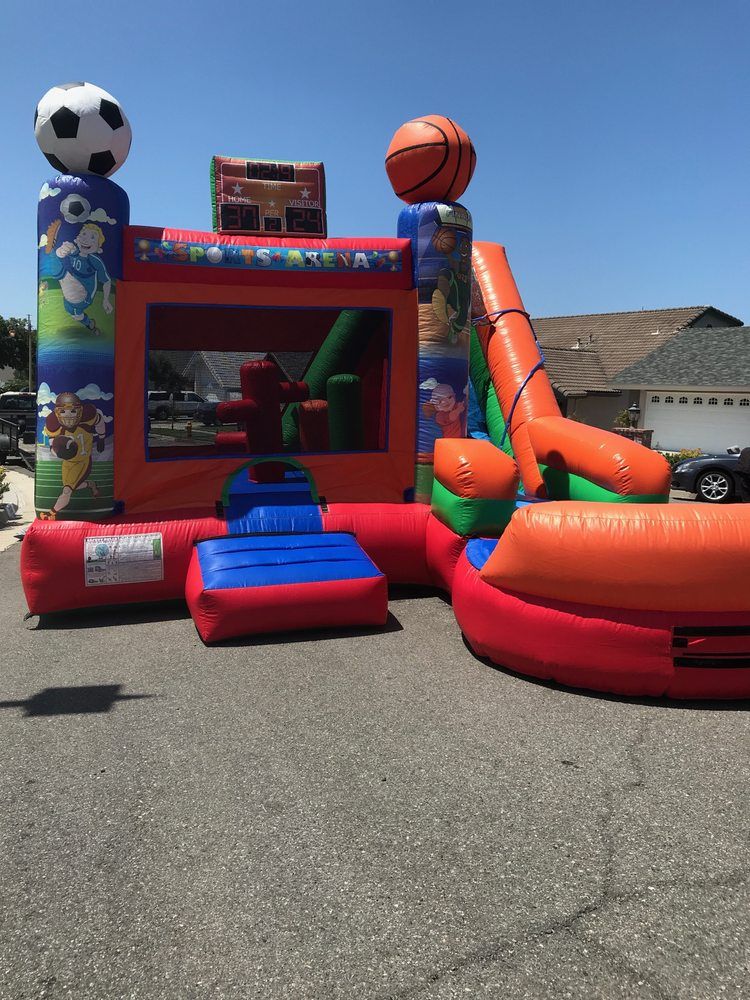 A bouncy house with a soccer ball and a basketball on top of it