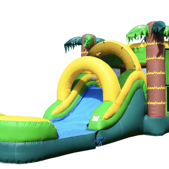 A green and yellow inflatable water slide with palm trees on it