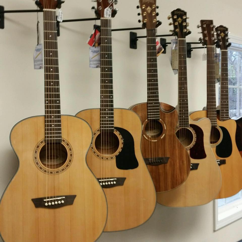 A row of guitars on a wall