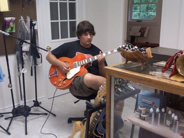 A child is playing a small guitar
