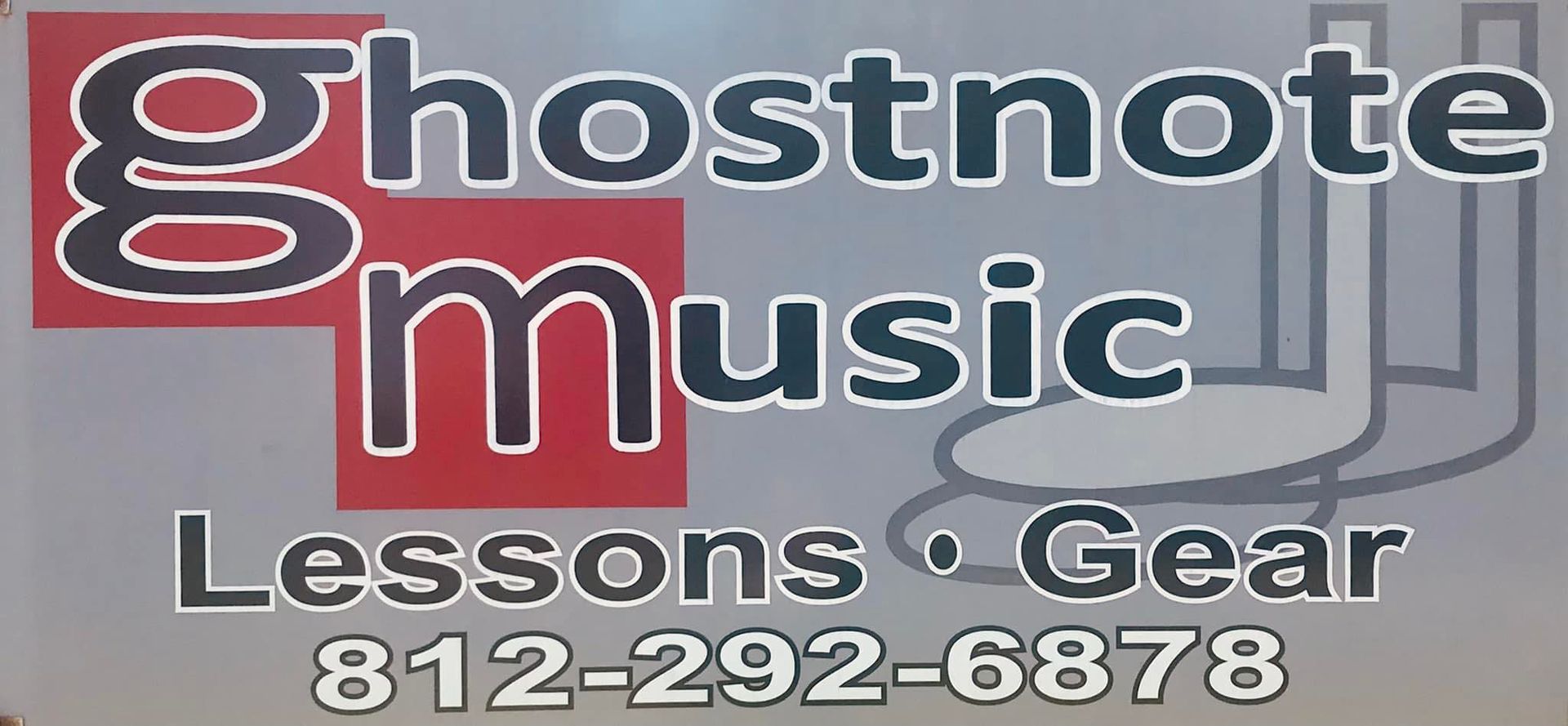 A sign for ghostnote music lessons and gear