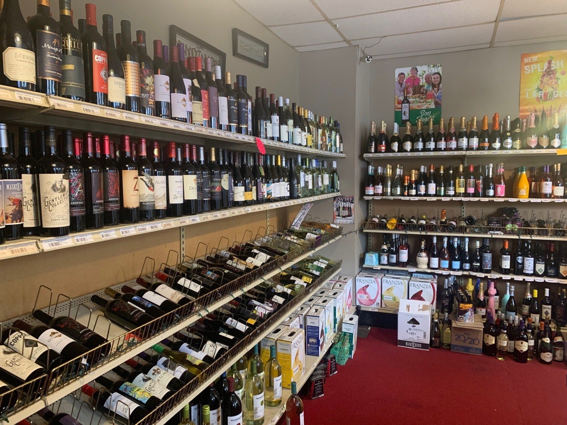 A liquor store filled with lots of wine bottles on shelves.