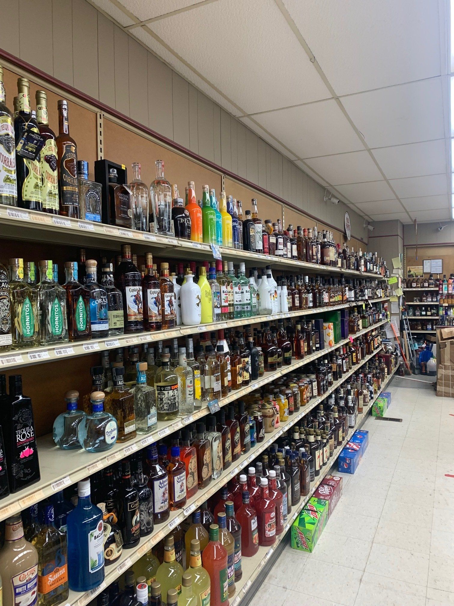 A liquor store filled with lots of bottles of liquor on shelves.