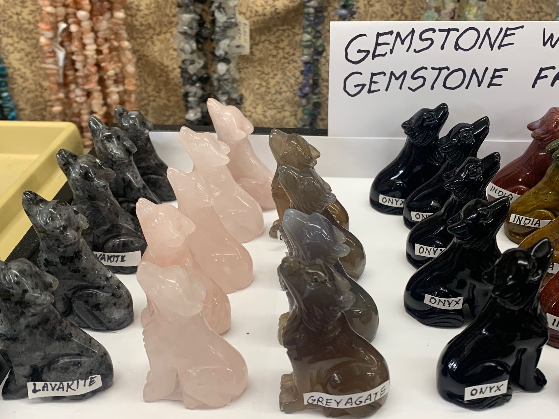 A table with a sign that says ' gemstone wolf ' on it