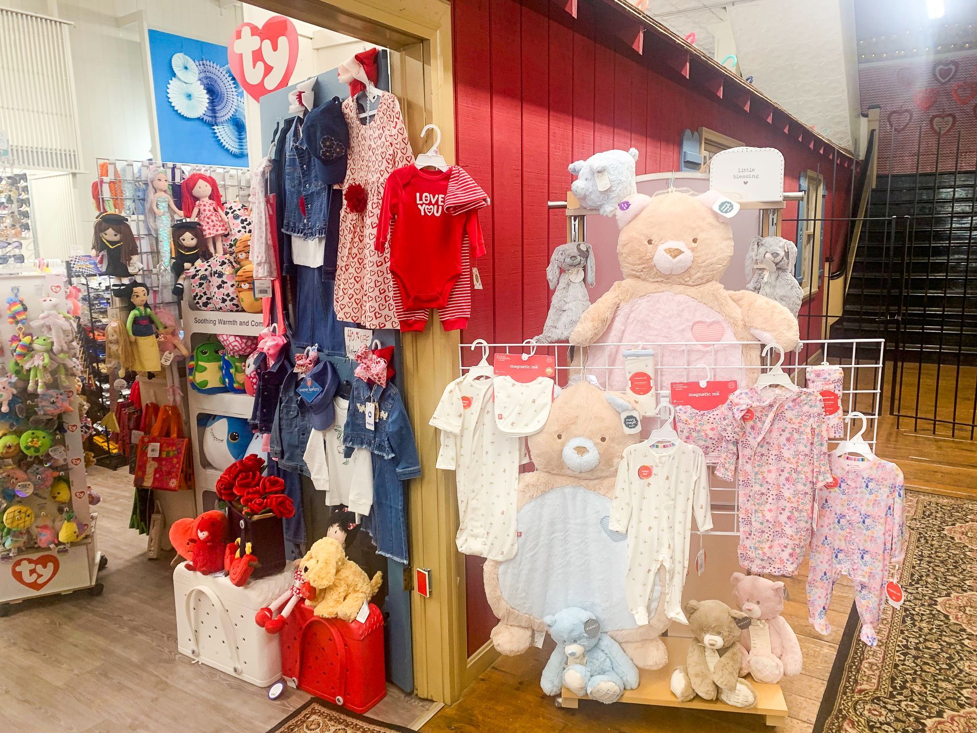 A store filled with lots of baby clothes and stuffed animals.