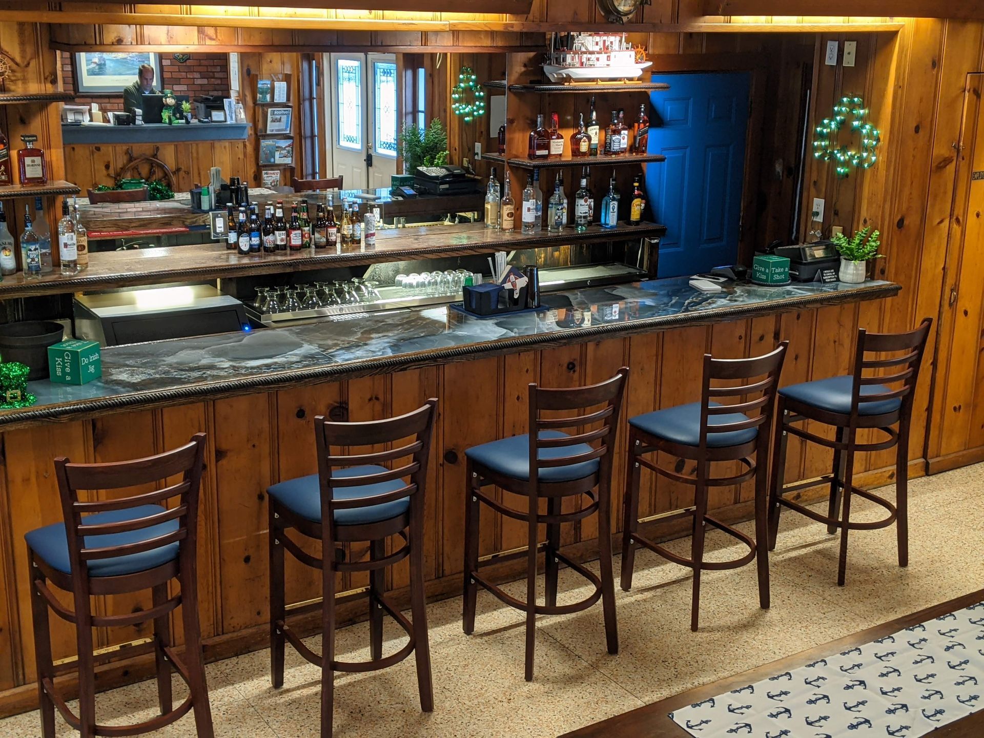 A bar with a long counter and a row of chairs